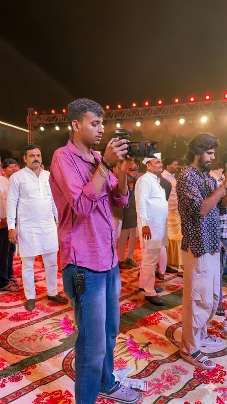 Anshul filming amongst guests at an evening celebration