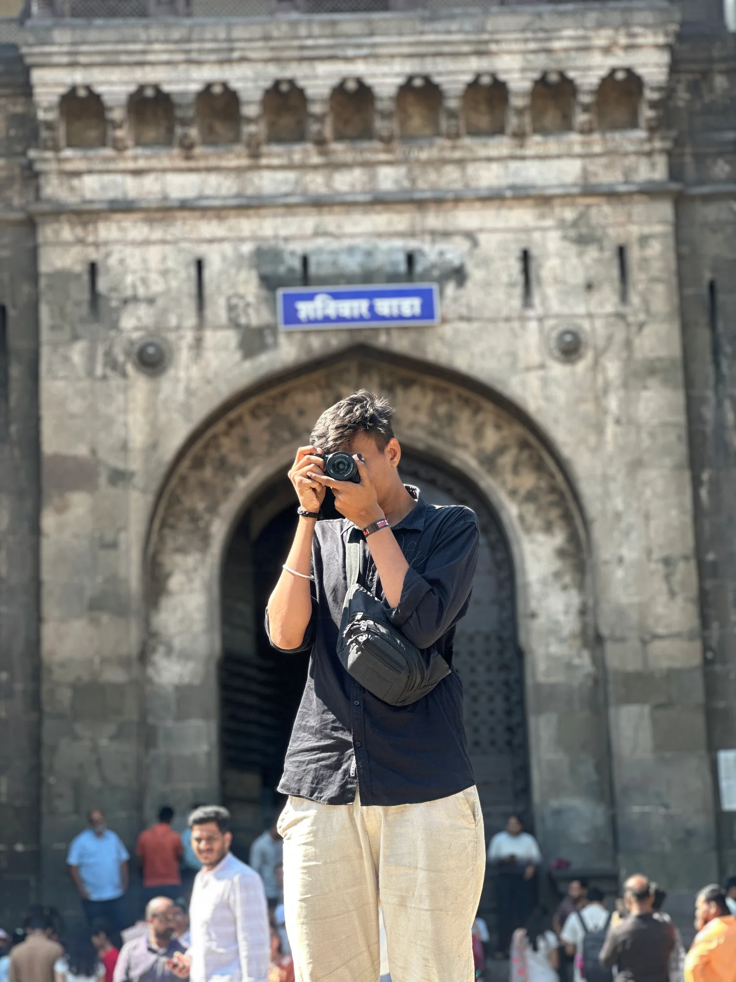 Anshul photographing at a stone gateway